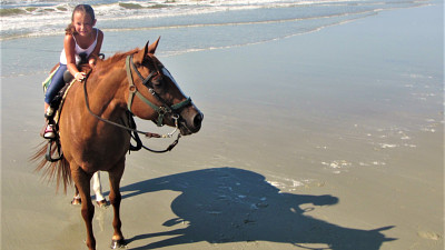 girl on horseback on the beach