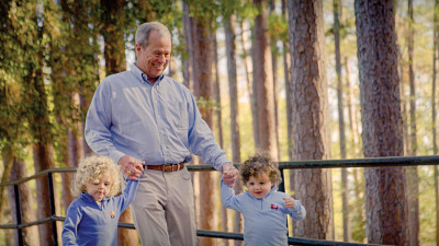 grandfather and two children out for a walk