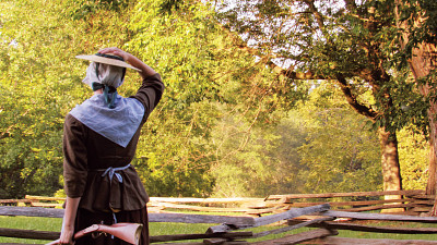 woman in period clothing holding rifle