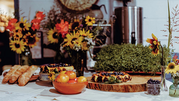 table set with bread, tomatoes, pastries 